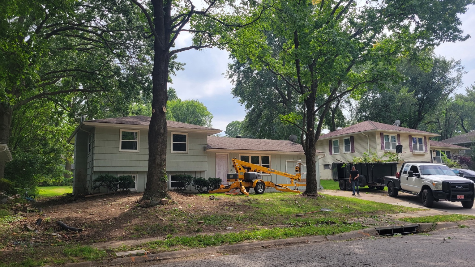 Tree removal equipment set up at a home in Warrensburg, MO